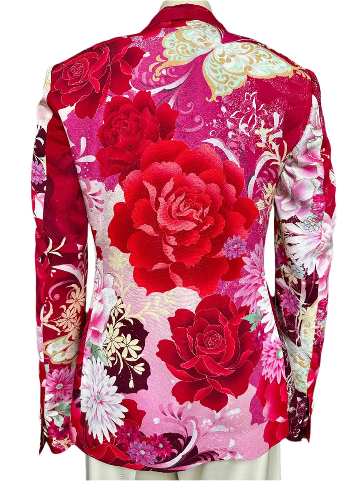 Floral patterned garment with red roses on a mannequin against a neutral background