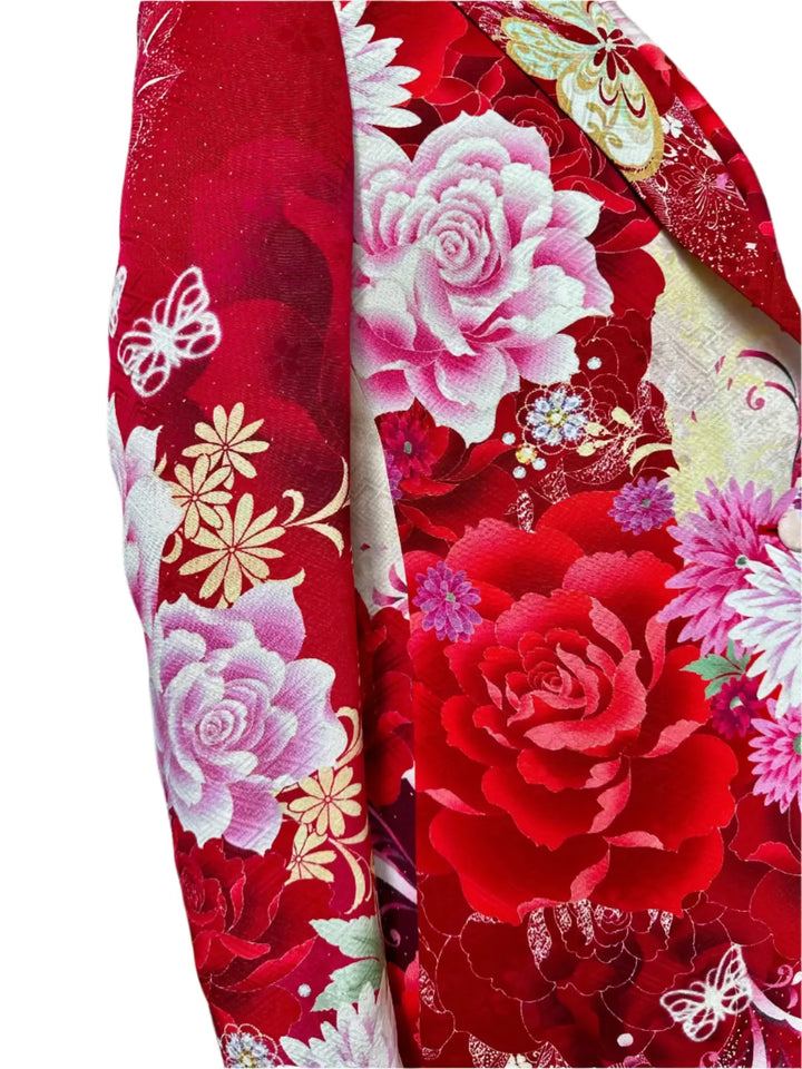 Close-up of a red fabric with floral and butterfly patterns