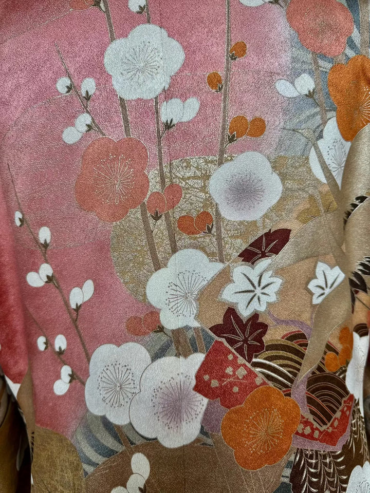 Floral patterned fabric with pink, orange, and white flowers on a textured background