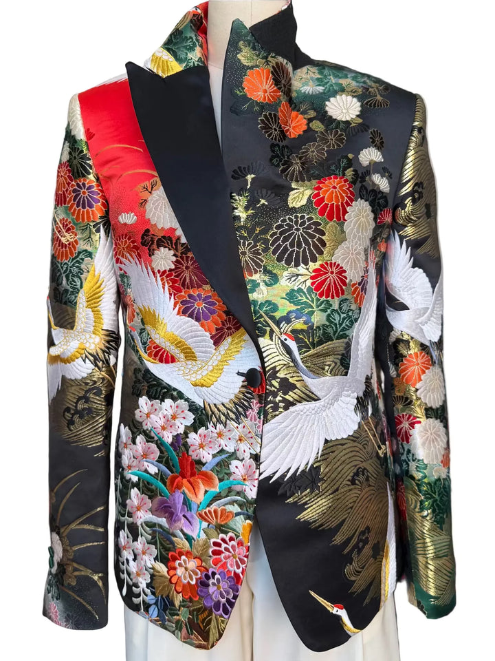 Front view of MIDNIGHT GARDEN KIMONO JACKET with Black satin lapel. Detail of gold embroidered cranes on vintage uchikake silk. Nigel Curtiss